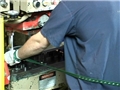 A machinist properly using a machine guard or safety device to avoid machine guarding hazards