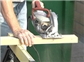 A worker using a power tool and following safe work practices to avoid serious injury while at work