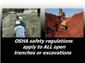 Workers in an open trench and a machine on an excavation site where OSHA safety regulations apply