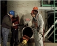 A safety manager training workers on confined space safety to avoid injury from workplace hazards